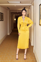 Silk midi dress with front tie detail, deep neckline, and long sleeves for statement evenings